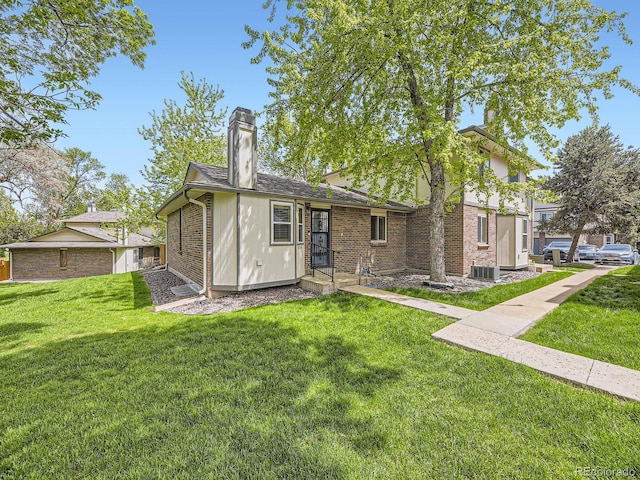 1720 S Ammons St Unit A, Lakewood, CO 80232 - back of house featuring a yard, a chimney, central AC, and brick siding