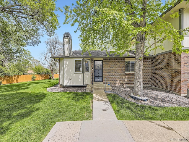 1720 S Ammons St Unit A, Lakewood, CO 80232 - view of front facade with brick siding and a chimney