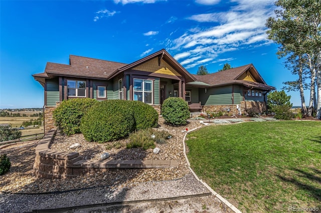 ranch-style house featuring a front lawn and stone siding