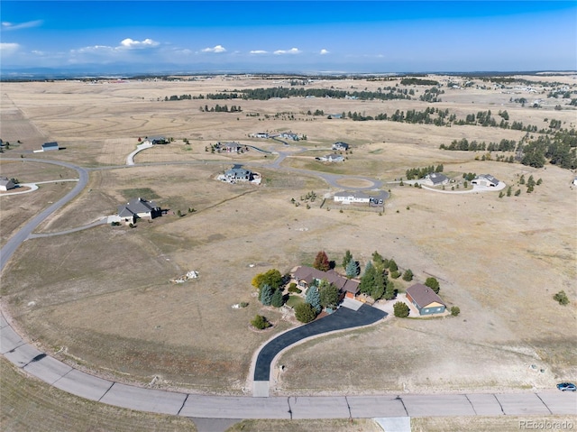 bird's eye view with view of desert and a rural view