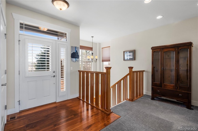 foyer with an inviting chandelier, visible vents, and recessed lighting