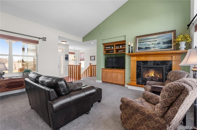carpeted living area featuring a fireplace and high vaulted ceiling