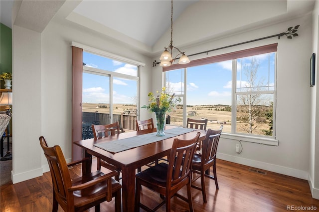 dining space with plenty of natural light, baseboards, visible vents, and dark wood-style flooring