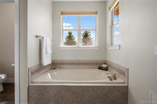 full bath featuring a bath and toilet