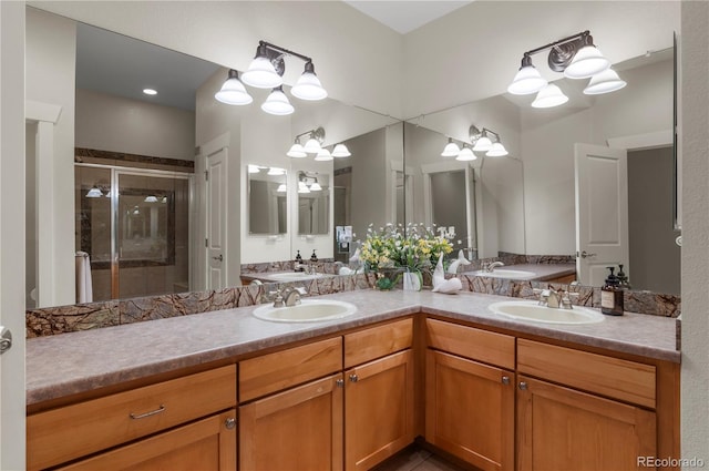 bathroom featuring double vanity, a shower stall, and a sink