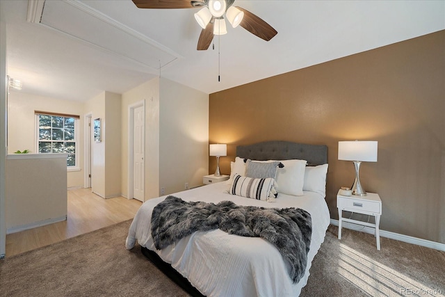 bedroom with ceiling fan, carpet, attic access, and baseboards