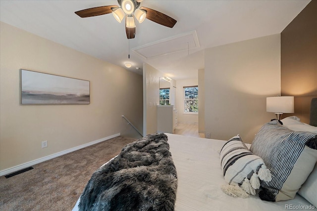 bedroom with carpet floors, visible vents, baseboards, vaulted ceiling, and attic access