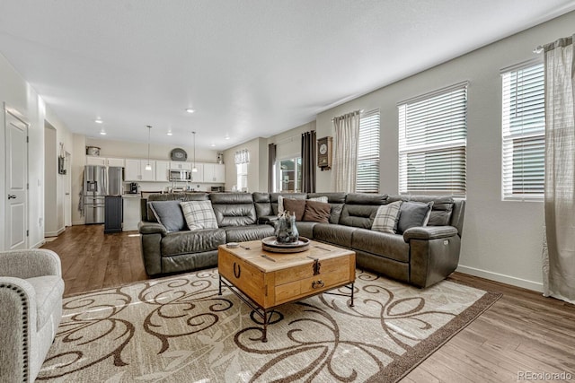 living area with wood finished floors and baseboards