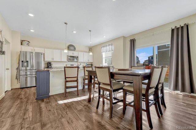 dining space with dark wood-type flooring