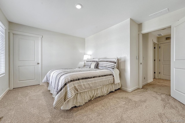 carpeted bedroom with visible vents and baseboards