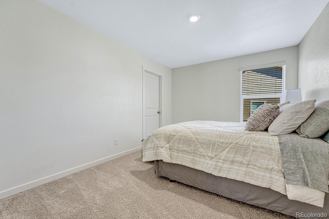 bedroom with baseboards and carpet floors