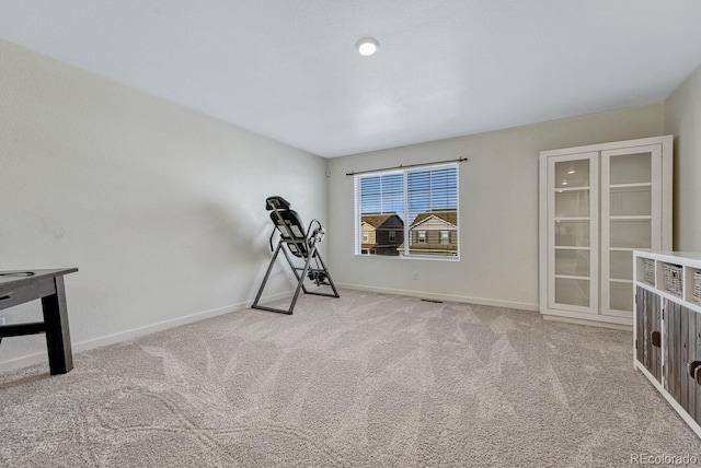 workout area featuring light colored carpet