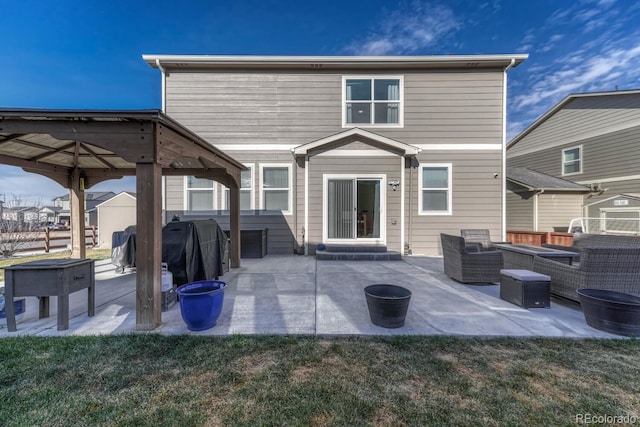 rear view of property featuring a yard, outdoor lounge area, a patio, and fence