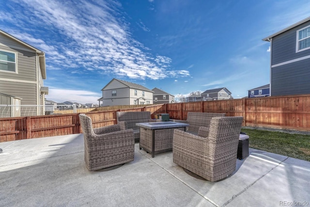 view of patio with an outdoor living space with a fire pit