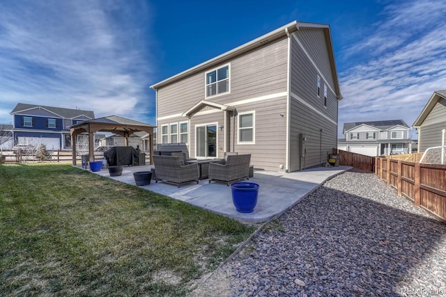 back of property with a gazebo, outdoor lounge area, a patio, and a lawn