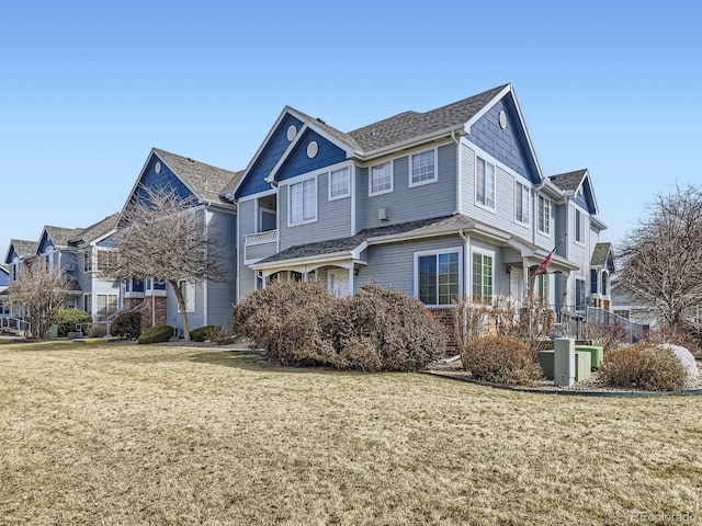 view of side of property featuring a yard and brick siding