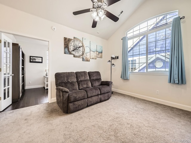 living room featuring visible vents, baseboards, carpet, and vaulted ceiling