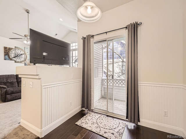 entryway with a wainscoted wall, lofted ceiling, a ceiling fan, and wood finished floors