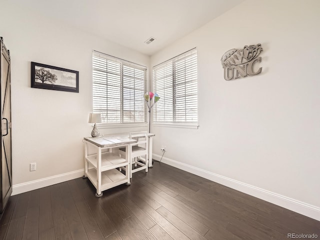 home office with visible vents, dark wood-style flooring, and baseboards