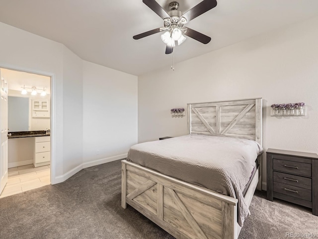 bedroom featuring ceiling fan, ensuite bathroom, baseboards, and carpet floors