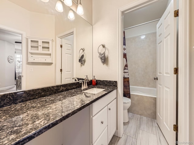 full bathroom with shower / tub combo with curtain, toilet, and vanity