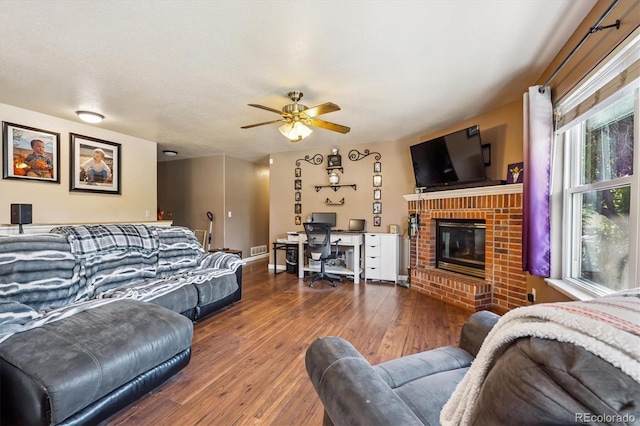 1115 Cherry Ct, Fort Lupton, CO 80621 - living area with hardwood / wood-style flooring, ceiling fan, a fireplace, and an office area
