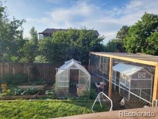 1115 Cherry Ct, Fort Lupton, CO 80621 - view of greenhouse featuring a vegetable garden