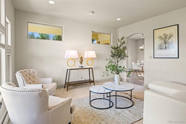 living room with an inviting chandelier and light colored carpet