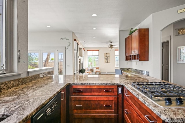 kitchen with stainless steel gas cooktop, dishwasher, light stone counters, and a wealth of natural light