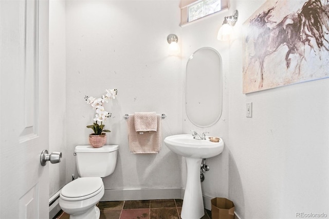 bathroom with toilet and a baseboard radiator