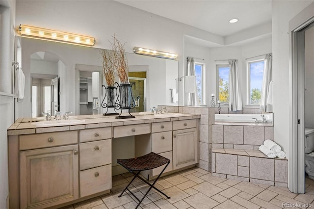 full bathroom featuring vanity, plus walk in shower, and toilet