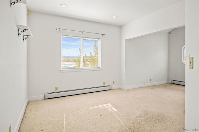 carpeted spare room with baseboard heating