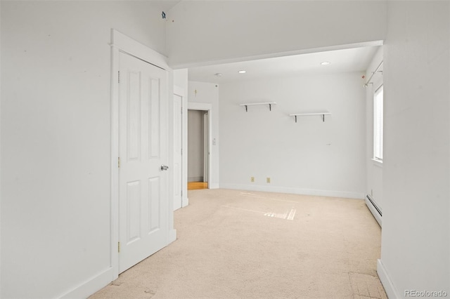 carpeted spare room with baseboard heating