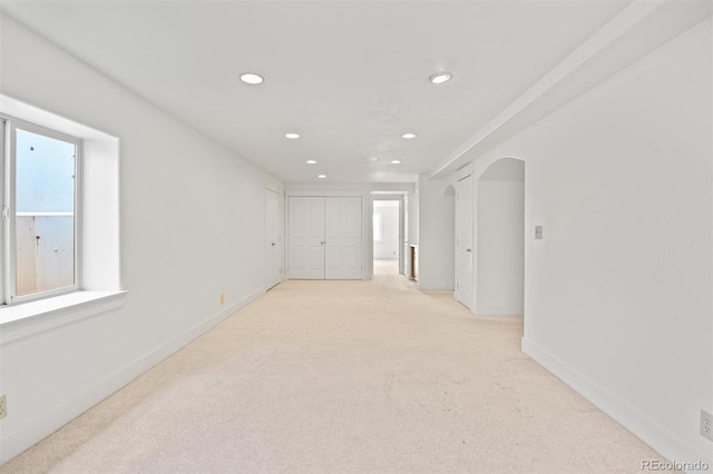 spare room featuring light colored carpet