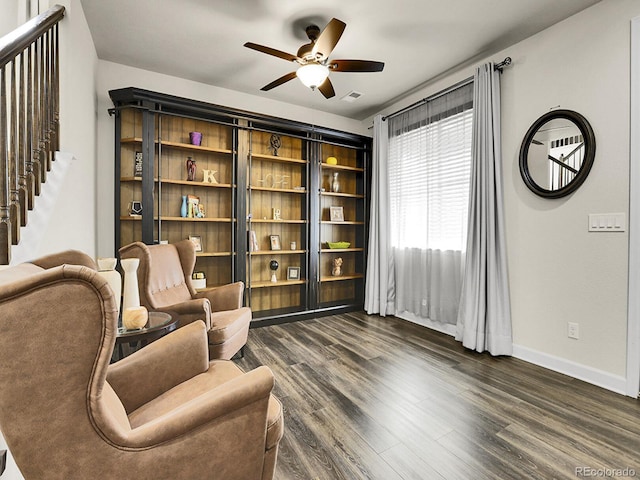9844 Truckee St, Commerce City, CO 80022 - sitting room with dark wood finished floors, visible vents, a ceiling fan, and baseboards