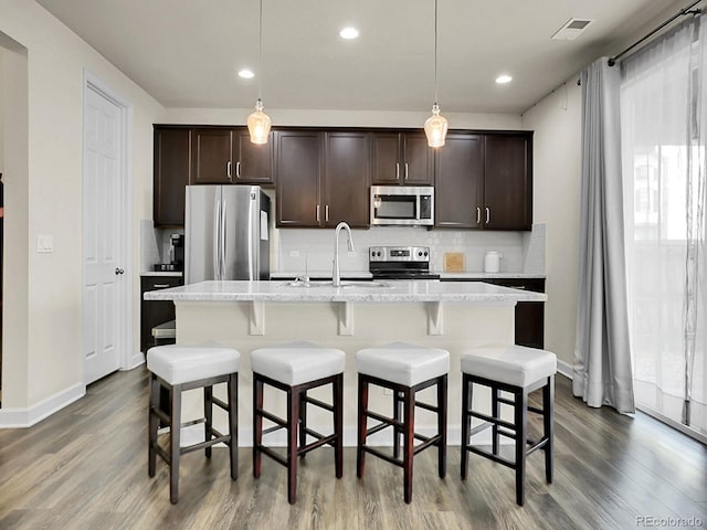 9844 Truckee St, Commerce City, CO 80022 - kitchen featuring dark wood finished floors, backsplash, appliances with stainless steel finishes, and a sink