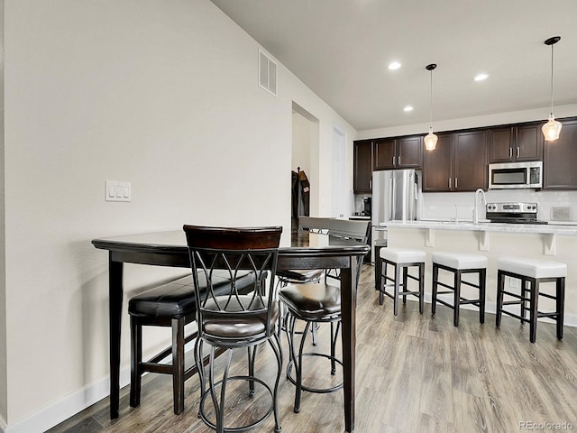 9844 Truckee St, Commerce City, CO 80022 - dining room with baseboards, light wood-style flooring, visible vents, and recessed lighting