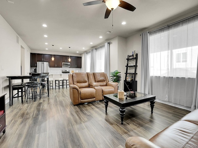 9844 Truckee St, Commerce City, CO 80022 - living room with a ceiling fan, wood finished floors, recessed lighting, and a healthy amount of sunlight