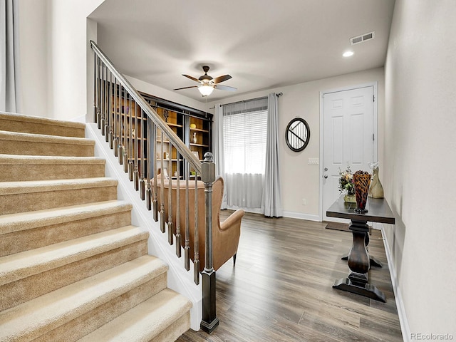 9844 Truckee St, Commerce City, CO 80022 - foyer featuring stairway, a ceiling fan, wood finished floors, baseboards, and visible vents