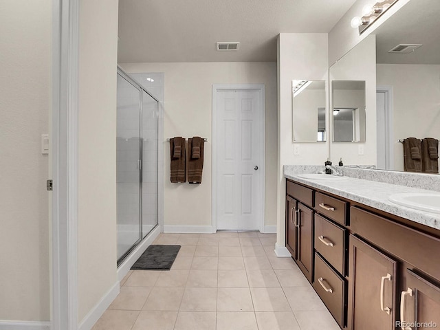 9844 Truckee St, Commerce City, CO 80022 - full bath with tile patterned floors, a sink, baseboards, visible vents, and a shower stall