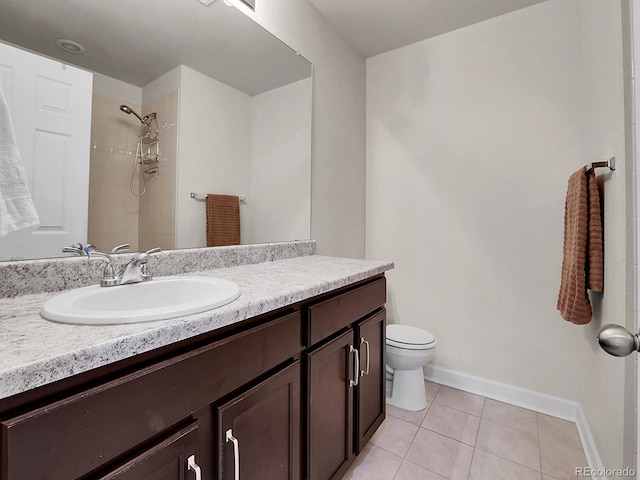 9844 Truckee St, Commerce City, CO 80022 - bathroom featuring a tile shower, tile patterned floors, toilet, vanity, and baseboards