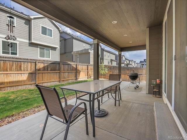9844 Truckee St, Commerce City, CO 80022 - view of patio featuring a residential view, a fenced backyard, and outdoor dining area