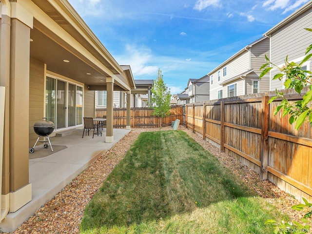9844 Truckee St, Commerce City, CO 80022 - view of yard with a fenced backyard, a residential view, and a patio