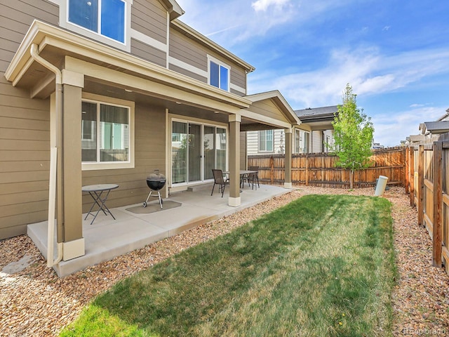 9844 Truckee St, Commerce City, CO 80022 - back of property with a patio area, a lawn, and a fenced backyard