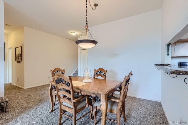 dining area featuring dark carpet