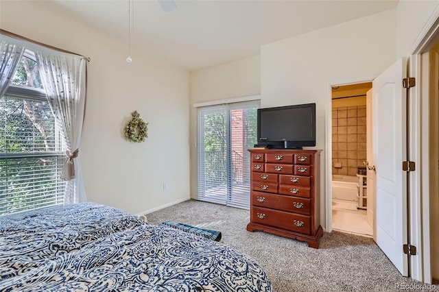 carpeted bedroom featuring access to outside, ensuite bathroom, and ceiling fan