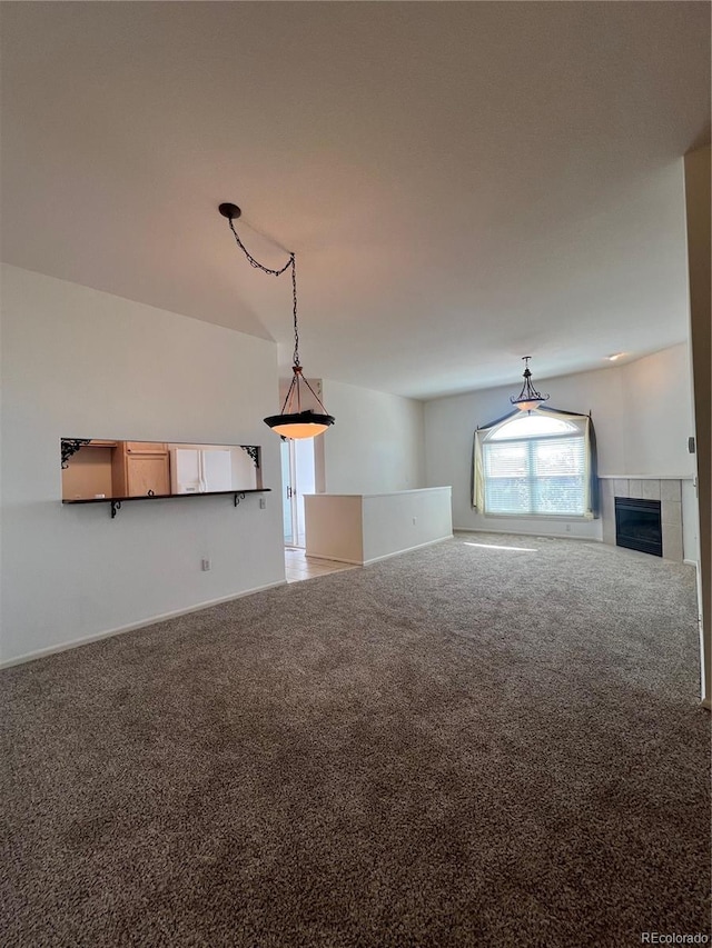 empty room featuring light colored carpet and a fireplace