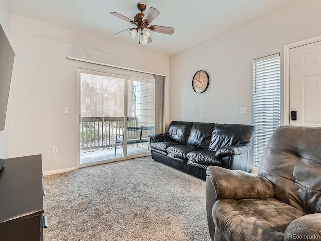 carpeted living room with a wealth of natural light and ceiling fan