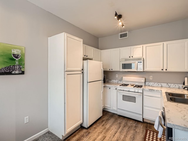 kitchen featuring visible vents, light countertops, white appliances, white cabinetry, and a sink