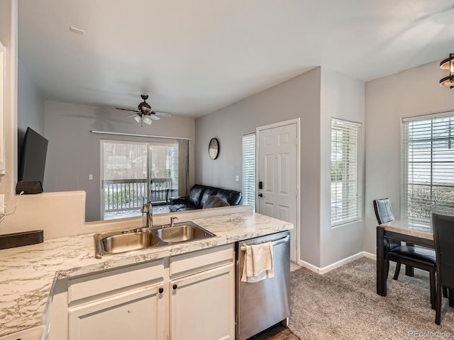 kitchen featuring a sink, carpet floors, stainless steel dishwasher, and plenty of natural light